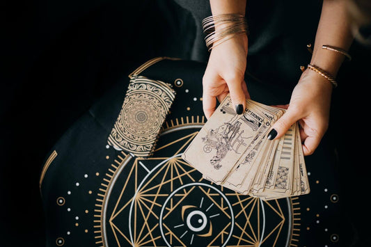 A person shuffling tarot cards