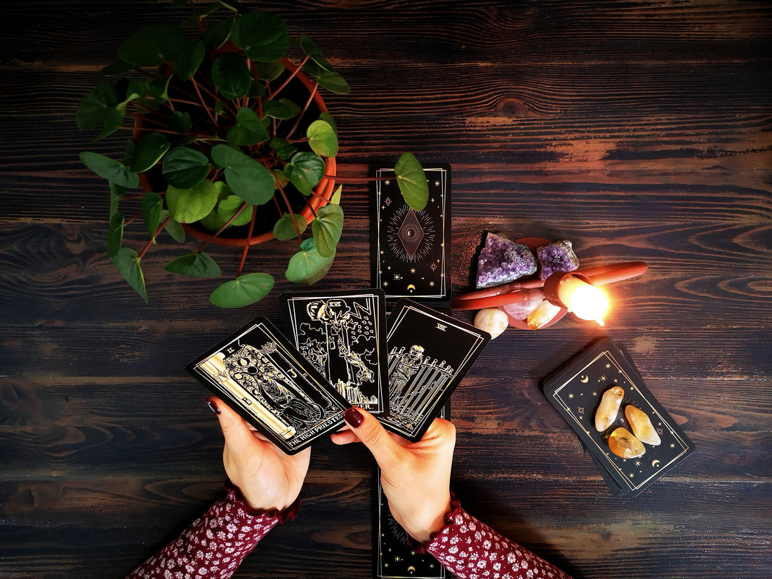 A preson holiding tarot cards in their hands