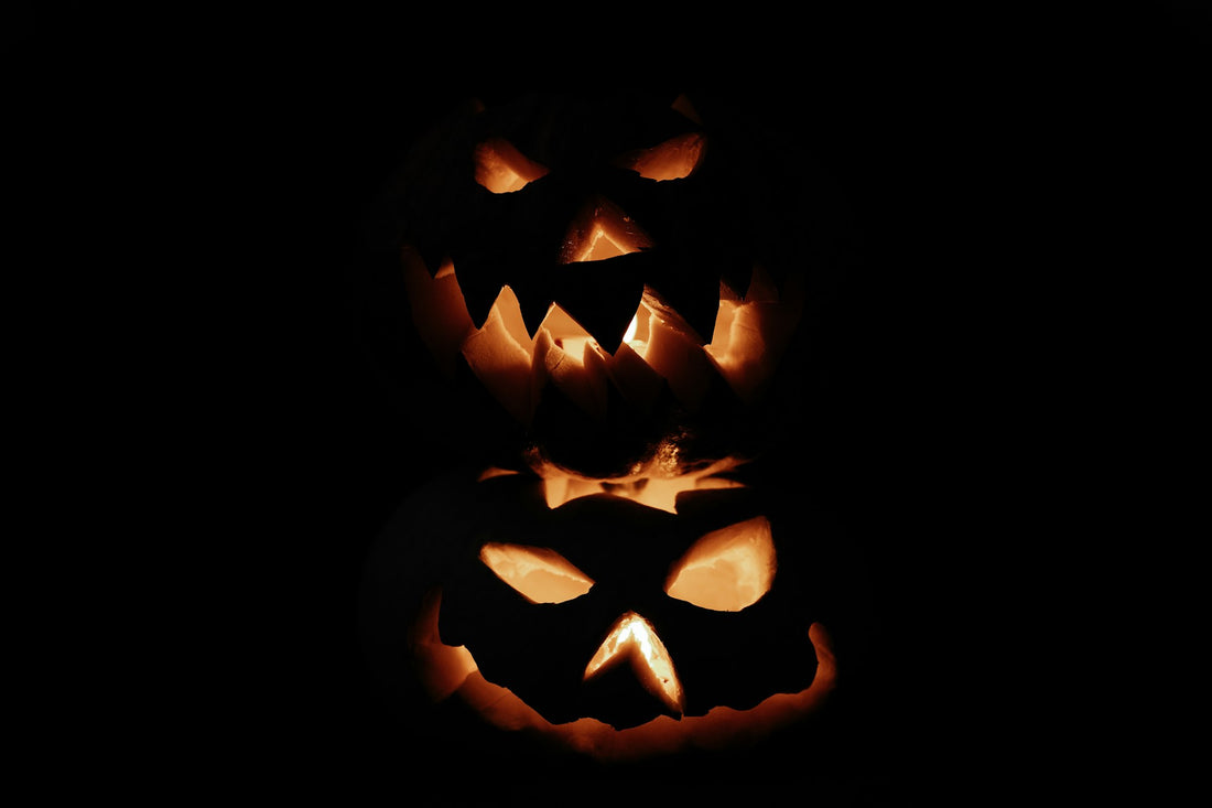 Glowing jack-o-lantern pumpkins in the dark on Samhain night