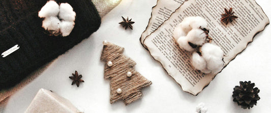 Cozy Christmas flat lay with wrapped gifts, pine branches and pine cones
