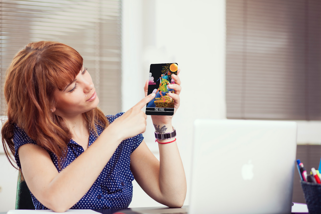 Person holding a tarot card